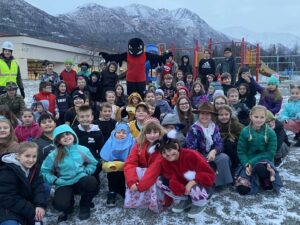 A group of Ravenwood children with the Ravenwood mascot.